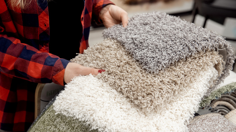 woman holding carpet samples