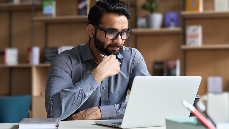 man doing research on laptop