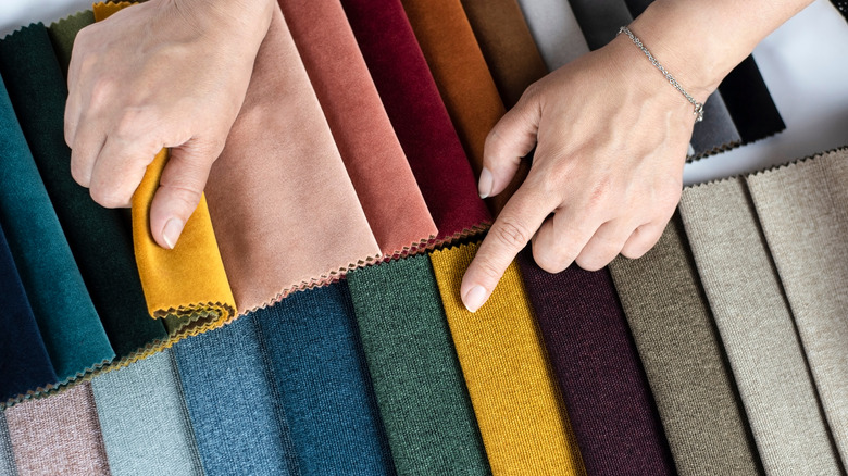 person looking through fabric swatches 