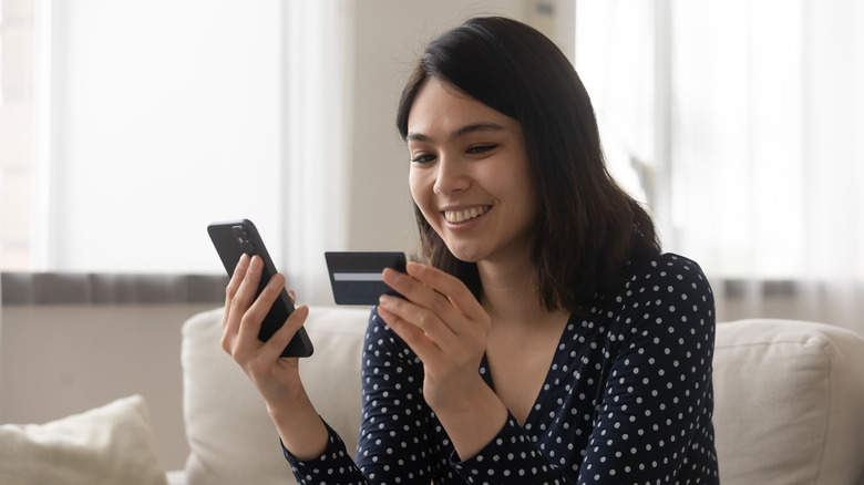 woman shopping on phone with card