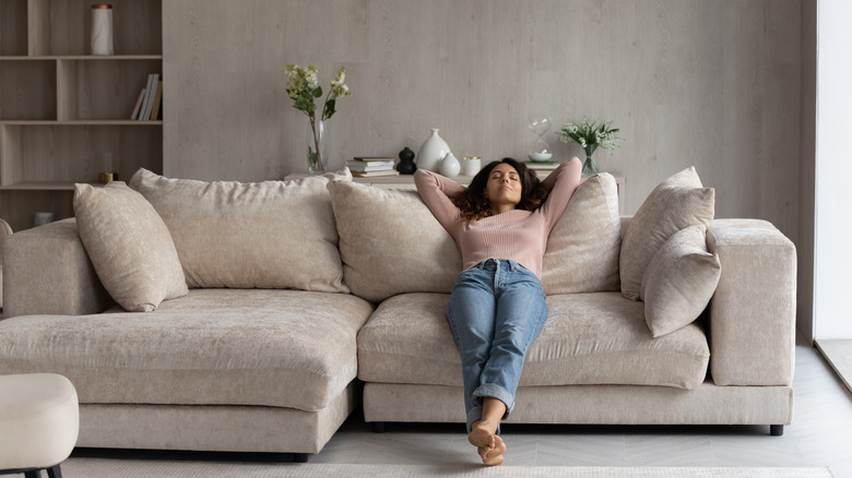 woman relaxing on sectional couch 