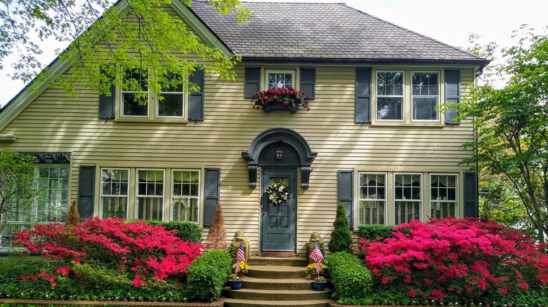 front of yellow siding house