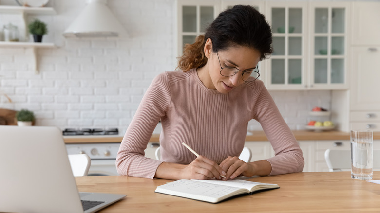 woman at laptop making a list 