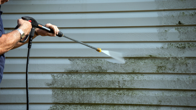 power washing siding of home