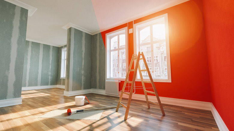 room being painted with ladder