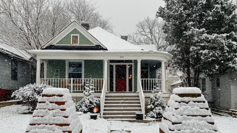 snow falling on suburban house
