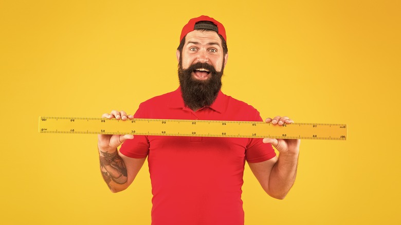 man with measuring stick