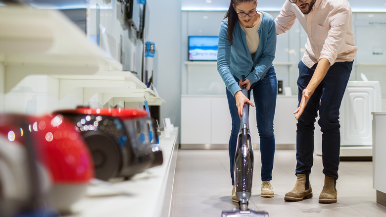 cute couple testing a vacuum 