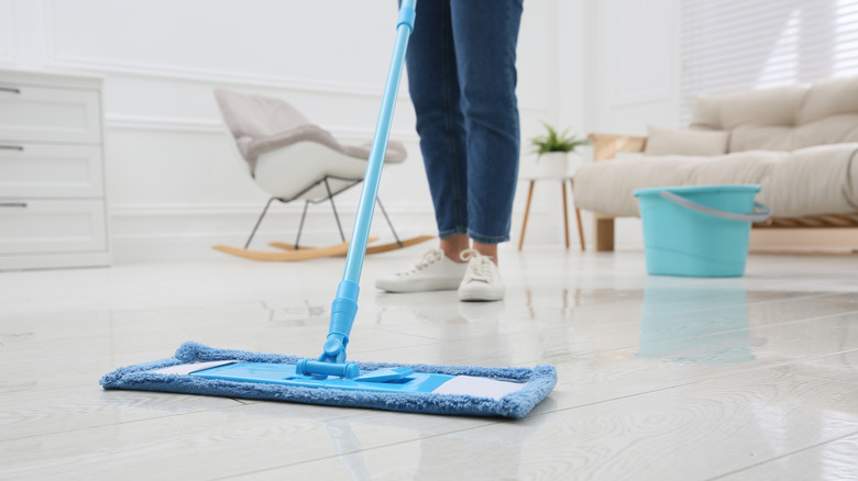 A person mopping a vinyl floor