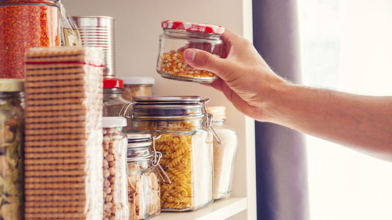 Person using glass food storage containers