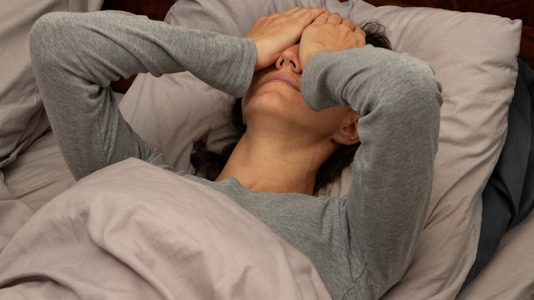 Stressed woman in bed