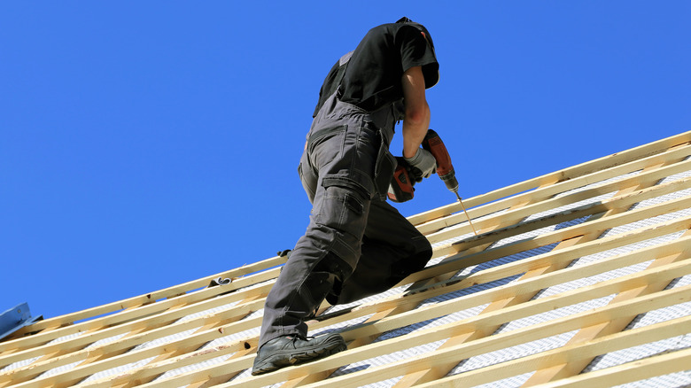 man working on steep roof