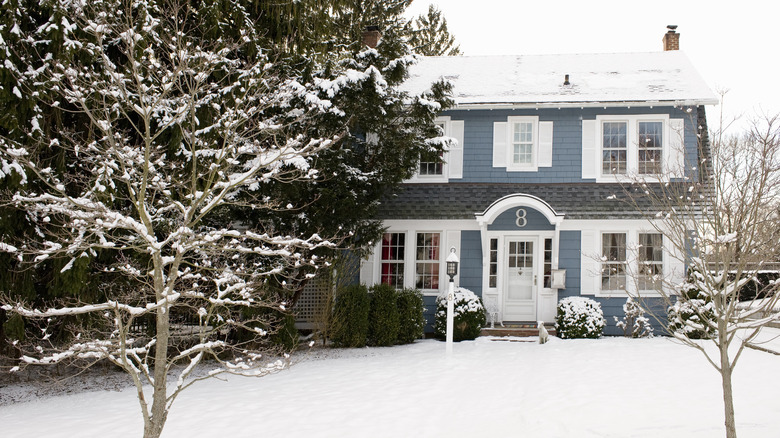 A house with a snow-covered front yard