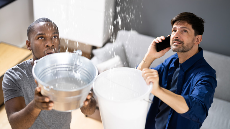 two friends catching water 