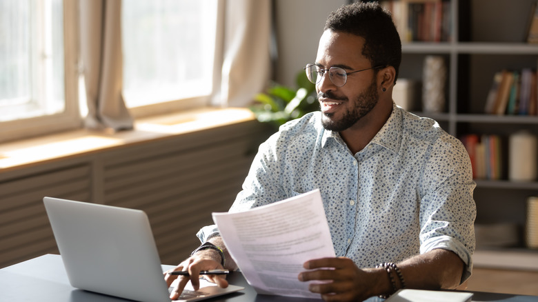 man looking at paperwork