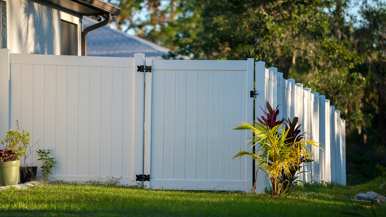 A white vinyl fence around a yard