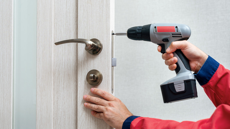 Fixing a door lock with a drill