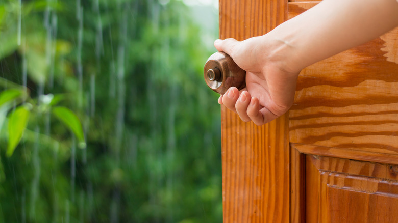 Raining outside of wooden door