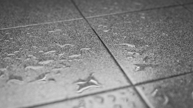 Water drops form on bathroom floor tiles