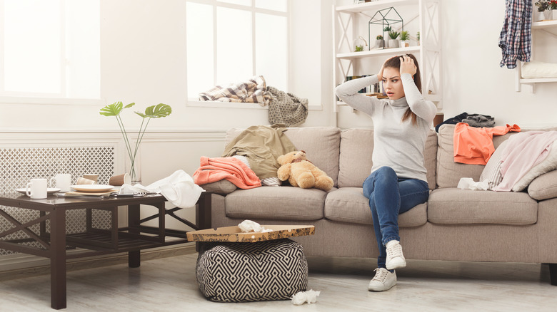 woman in cluttered room