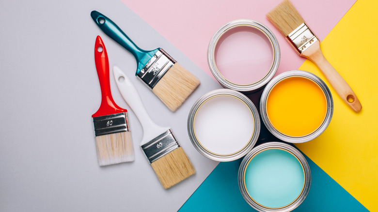 close-up paint cans and brushes