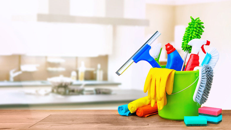 bucket of cleaning supplies in kitchen