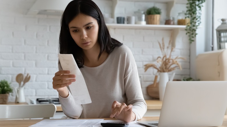 Woman calculating receipt