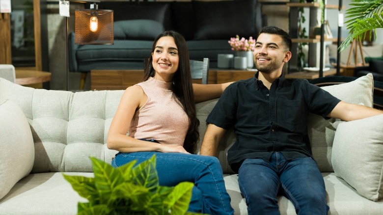 Newlyweds on couch in store