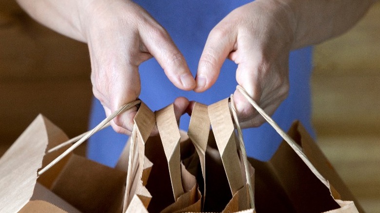 Hands holding shopping bags