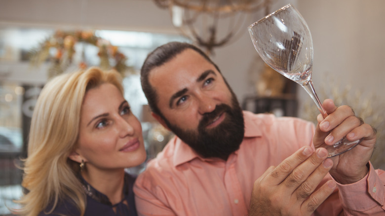 couple shopping for wine glass