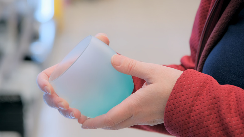 woman holding glass cup