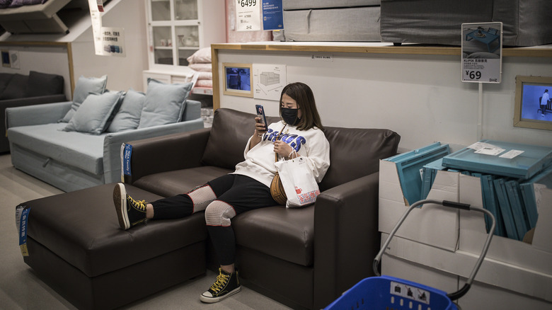 Woman sitting on couch in IKEA