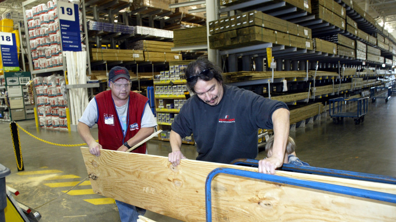 lowe's employee loading wood for customer