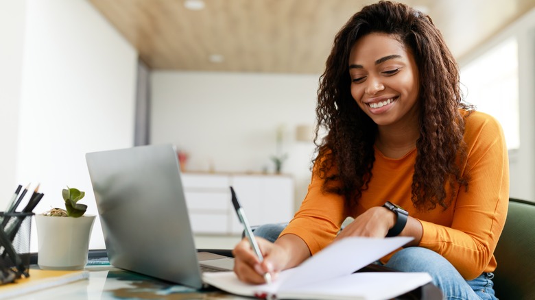 woman working at computer with pen