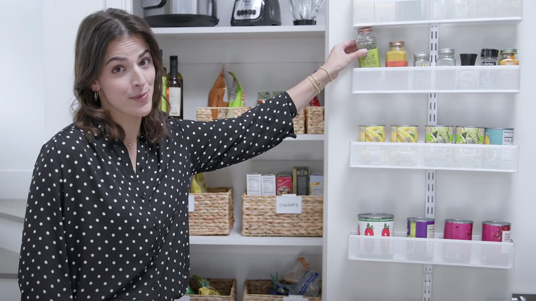 Woman organizing pantry with shelves