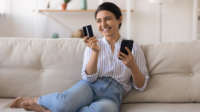 woman on phone with card