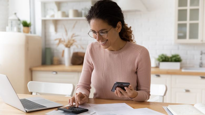 woman doing paperwork in kitchen