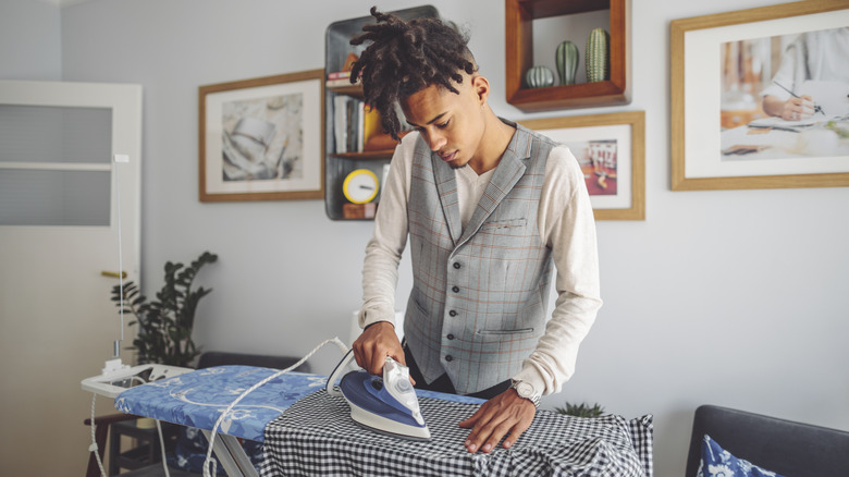 person ironing shirt