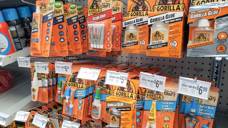 Several formulations of Gorilla Glue hanging at the store