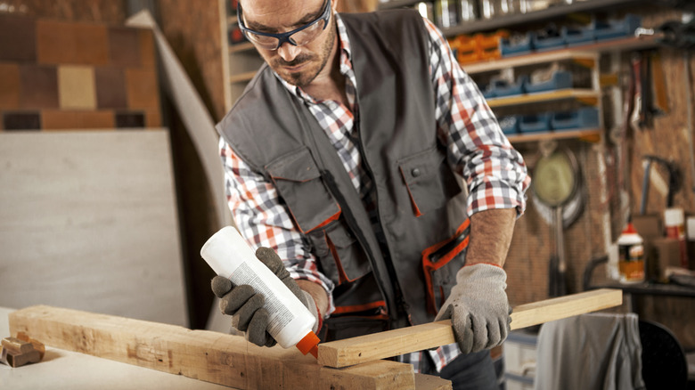 Man applying wood glue to a joint