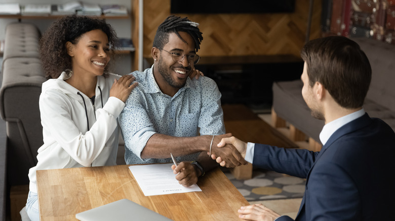 young couple meeting with realtor