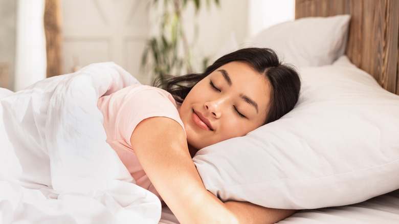 woman sleeping on white pillow