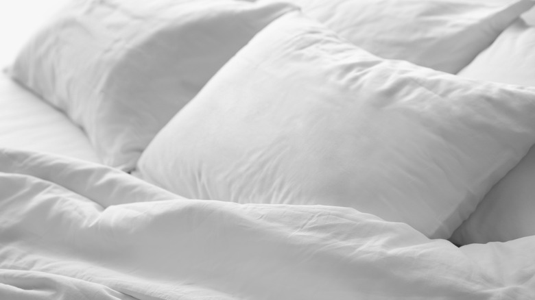 two white pillows on white bed