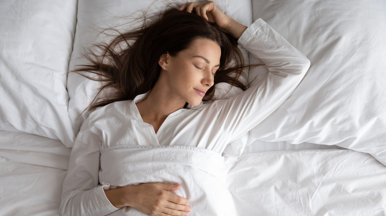 woman sleeping on large pillows