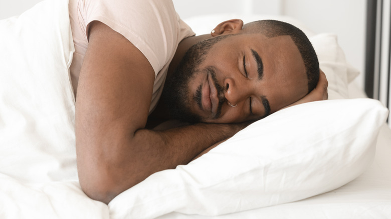 man sleeping on soft pillow