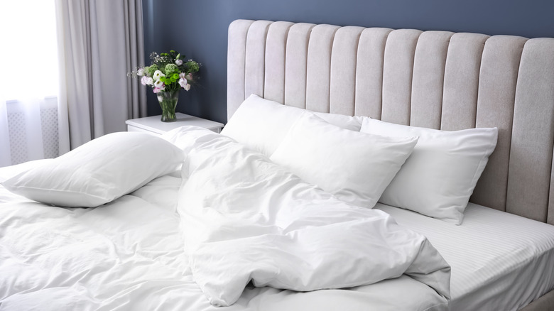 white pillows on unmade bed