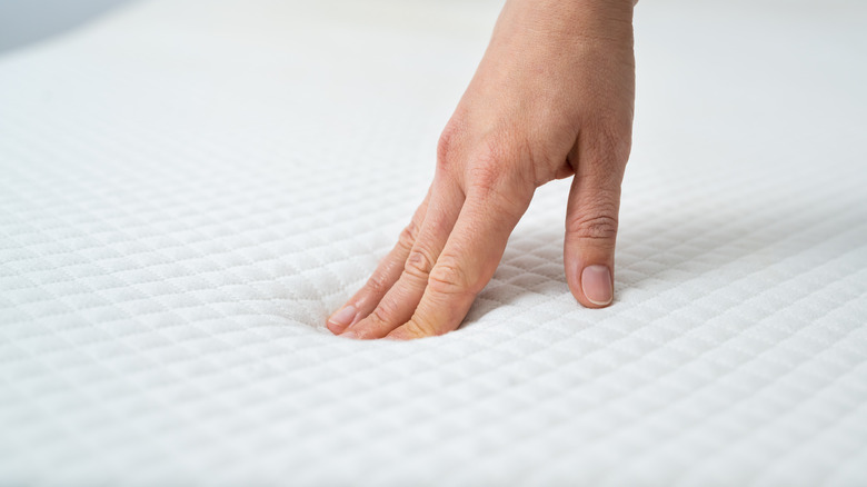 hand pressing mattress testing firmness