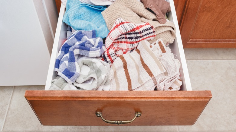 unorganized kitchen towel drawer