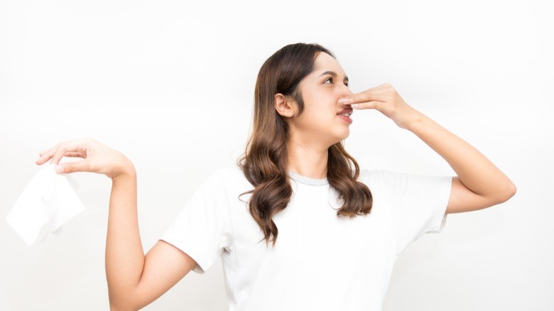 Woman throwing away dirty pads