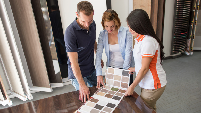 People looking at flooring swatches